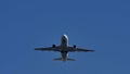 Plane flying, silhouette, closeup view from below the plane Royalty Free Stock Photo