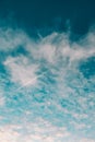 Plane flying on the sky between the clouds in a minimalistic image with a saturated blue color Royalty Free Stock Photo