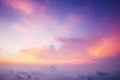 a plane flying in the sky with a pink and blue sky in the back ground and clouds in the foreground and a purple and yellow sky in