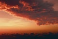 a plane flying in the sky with a sunset in the backgrouund of it and clouds in the foreground and a plane in the foreground