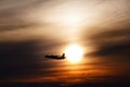 plane flying at sun in sunset sky. airplane in the air. transportation concept with space for text. Silhouette of a big Royalty Free Stock Photo