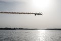 Plane flying upside down upon the lake Royalty Free Stock Photo