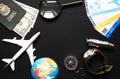 plane, globe, passport, dollars, compass, clock, magnifier,knife on black background, travel concept Royalty Free Stock Photo