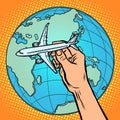 Plane in hand. metaphor of flight to the Eastern hemisphere