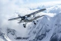 the plane hangs over mountains with snow Royalty Free Stock Photo