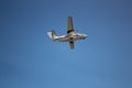 The plane hovering in the blue sky. Royalty Free Stock Photo