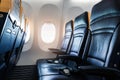 Plane interior - cabin with modern leather chair for passenger of airplane. Royalty Free Stock Photo