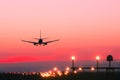 Plane lands at an airfield at the sunset Royalty Free Stock Photo