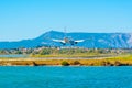 Plane landing at Corfu international airport in Greece Royalty Free Stock Photo