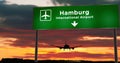 Plane landing in Hamburg Germany airport with signboard