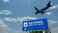 Plane landing in Katowice Poland airport with signboard