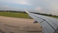 Plane landing. The reduction of a passenger plane over the europian country. Wing in the window.