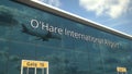 Commercial plane landing reflecting in the windows with O'Hare International Airport text. 3d rendering