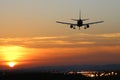 Plane landing at runway on the background of sunset Royalty Free Stock Photo