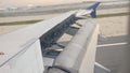 Aircraft wing outside board aileron lifting up for maneuvering speed while take off at the airport.