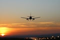 Plane lands at an airfield on the background of sunset Royalty Free Stock Photo