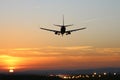 Plane lands at an airfield on the background of sunset Royalty Free Stock Photo