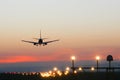 Plane lands at an airfield on the background of sunset Royalty Free Stock Photo