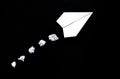 A plane made of paper on a black background.The plane is made by hand. Origami paper. The theme of travel. Royalty Free Stock Photo