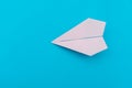 A plane made of paper on a blue background.The plane is made by hand. Origami paper. Royalty Free Stock Photo