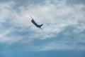 AN-26 plane makes a U-turn at a steep angle before landing at sunny day with cloud sky