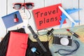 plane, map, passport, money, watch, camera, notepad with text & x22;T