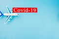 Plane model toy and COVID-19 text concept. Flight cancellation due to the impact of coronavirus