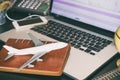 Plane on office computer desktop for aviation transportation concept Royalty Free Stock Photo