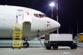 Plane parked at the airport at night, view nose cockpit. Royalty Free Stock Photo