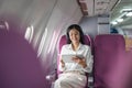 Plane passenger business woman working in airplane cabin during flight with in flight wifi typing writing on tablet