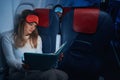 Plane passenger in sleep mask reading a book Royalty Free Stock Photo