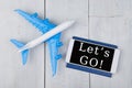 plane, passport and smartphone with text & x22;Let& x27;s go!& x22;