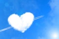 The plane pierces a cloud of heart like an arrow of cupid. Valentine`s Day Concept