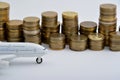 Plane plastic toy with coins isolated on white Royalty Free Stock Photo