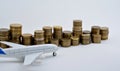 Plane plastic toy with coins isolated on white Royalty Free Stock Photo