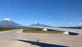 The plane prepares for takeoff at Yelizovo airport. A beautiful view of a group of volcanoes. View of the aircraft wing from the w