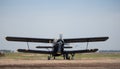 The plane is preparing to take off at the airdrome on sky background.