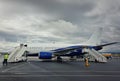 Plane ready for boarding at airport in a cloudy day. Passenger transportation at Charles de Gaulle Airport in Paris. Travel and