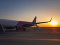 Plane ready for boarding at airport with the view to the sunrise. Travel and vacation concept