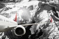 Plane red black white cloud travel transportion airplane mountains Royalty Free Stock Photo