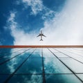 Plane in the sky, business building in foreground. Movement to the goal, concept