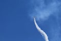 Plane smoke at an airshow across the blue sky Royalty Free Stock Photo
