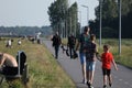 Plane spotter walking by Polderbaan runway, Amsterdam Airport