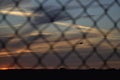 Small plane at sunset through barbed wire fence in warsaw Royalty Free Stock Photo
