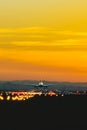 The plane takes off from the airport runway during sunset at dusk Royalty Free Stock Photo