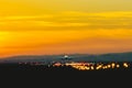 The plane takes off from the airport runway during sunset at dusk Royalty Free Stock Photo