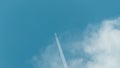The plane takes off from the cloud. Clear transparent beautiful blue sky. White fluffy cloud. A flying plane leaves a trace of the Royalty Free Stock Photo