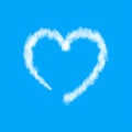 Plane track or white cloud heart isolated on blue background Royalty Free Stock Photo