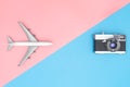 Plane and vintage camera on blue pink background travel concept Royalty Free Stock Photo