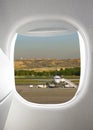 Plane window with airfield Royalty Free Stock Photo